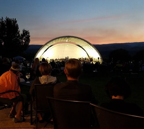 In the summer of 2017 Vince & Carol created a beautiful amphitheater called STAGE B, directly in front of the winery tasting room that holds approximately 1,000 people. The inaugural concert was performed by the Yakima Symphony Orchestra. Over the last few years many professional musicians have played on this stage, as well as our yearly open mic over Labor Day Weekend for aspiring musicians.  We have had musicals & dance festivals, as well as food & wine pairing classes, & festive dinners on this stage. In the high heat of the summer it can also serve as a wonderful shaded area for our wine tasters. Community members are encouraged to book Stage B for their artistic endeavors.
